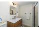 Bathroom featuring a modern vanity, mirror, and a glass enclosed shower at 402 E 46Th St, Indianapolis, IN 46205