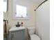 Bathroom featuring a single vanity and a toilet next to the bath with curtain at 402 E 46Th St, Indianapolis, IN 46205