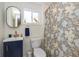 Bathroom with blue vanity, patterned shower curtain, and decorative accents at 402 E 46Th St, Indianapolis, IN 46205