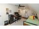 Bright bedroom with a ceiling fan, a desk and a bed with orange and yellow pillows at 402 E 46Th St, Indianapolis, IN 46205