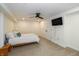 Finished basement bedroom with a ceiling fan, tv, and a comfy looking bed at 402 E 46Th St, Indianapolis, IN 46205