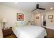 Bright bedroom with neutral walls, wood floors, ceiling fan, and classic-style furnishings at 402 E 46Th St, Indianapolis, IN 46205
