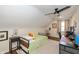 Bright bedroom featuring a ceiling fan, and a striped coverlet on the bed at 402 E 46Th St, Indianapolis, IN 46205