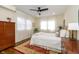 Sunlit bedroom with neutral walls, wood floors, ceiling fan, an area rug and bright natural light at 402 E 46Th St, Indianapolis, IN 46205