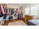 Walk-in closet with custom shelving, hanging racks, wood floors, and natural light at 402 E 46Th St, Indianapolis, IN 46205