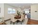 Dining room with a large table, seating, hardwood floors, and natural lighting at 402 E 46Th St, Indianapolis, IN 46205