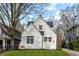 Charming white brick home with well-manicured lawn and fresh spring flowers at 402 E 46Th St, Indianapolis, IN 46205