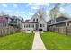 Charming home with a well-maintained lawn, inviting walkway, patio seating, and mature trees at 402 E 46Th St, Indianapolis, IN 46205