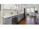 Modern kitchen with stainless steel appliances, white cabinets, and hardwood floors at 402 E 46Th St, Indianapolis, IN 46205