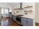 Kitchen with white subway tile backsplash, stainless steel appliances, and wooden accents at 402 E 46Th St, Indianapolis, IN 46205