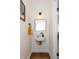 Stylish powder room featuring modern fixtures, an accent mirror, and unique light fixture at 402 E 46Th St, Indianapolis, IN 46205