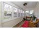 Bright sunroom featuring large windows, wooden floors, and comfortable seating, perfect for relaxing at 402 E 46Th St, Indianapolis, IN 46205