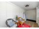Inviting sunroom with white brick walls, seating, wood floors, and a coat rack near the entrance at 402 E 46Th St, Indianapolis, IN 46205