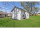 Old barn with faded white painted exterior, grass lawn and blue skies at 402 N 19Th Ave, Beech Grove, IN 46107