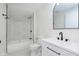 Updated bathroom features modern fixtures, a tub with a shower, a sleek vanity, and a contemporary mirror at 402 N 19Th Ave, Beech Grove, IN 46107