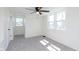Bright bedroom with two windows, ceiling fan, neutral carpet, and clean, white painted walls at 402 N 19Th Ave, Beech Grove, IN 46107