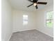Bright bedroom with neutral carpet, two windows, and ceiling fan at 402 N 19Th Ave, Beech Grove, IN 46107