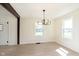 Elegant dining area featuring modern light fixture, and new flooring, perfect for hosting gatherings at 402 N 19Th Ave, Beech Grove, IN 46107