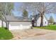 A white two-story home next to a two car detached garage with a driveway and lawn at 402 N 19Th Ave, Beech Grove, IN 46107