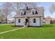 Well-maintained two-story home with a pathway, green lawn, light siding, and mature trees in a suburban setting at 402 N 19Th Ave, Beech Grove, IN 46107
