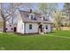 Classic two-story home showcasing light-colored siding, a well-kept lawn, and a detached garage at 402 N 19Th Ave, Beech Grove, IN 46107