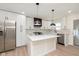 Modern kitchen with stainless steel appliances, quartz countertops, and ample cabinet space with a kitchen island at 402 N 19Th Ave, Beech Grove, IN 46107