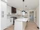 Bright kitchen boasts white cabinets, modern appliances, and a stylish island with white countertop at 402 N 19Th Ave, Beech Grove, IN 46107