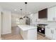 Well-lit kitchen with stainless steel appliances, a center island, and an open view to the dining area at 402 N 19Th Ave, Beech Grove, IN 46107