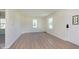 Bright living room with light wood flooring, white walls, and natural light streaming through the windows at 402 N 19Th Ave, Beech Grove, IN 46107