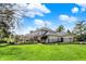 Lush backyard featuring a well-manicured lawn, mature trees, and blooming bushes at 4339 Royal Pine Blvd, Indianapolis, IN 46250