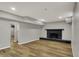 Spacious finished basement area featuring wood flooring and a vintage-style brick fireplace at 4339 Royal Pine Blvd, Indianapolis, IN 46250