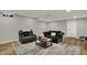Finished basement area with leather chair, couch and coffee table atop a patterned rug at 4339 Royal Pine Blvd, Indianapolis, IN 46250