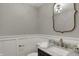 Stylish powder room features marble countertops, gold fixtures, and classic wainscoting for a refined touch at 4339 Royal Pine Blvd, Indianapolis, IN 46250