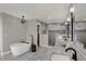 Gorgeous bathroom featuring double sinks, tiled shower, soaking tub, and stylish fixtures at 4339 Royal Pine Blvd, Indianapolis, IN 46250