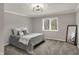 Carpeted bedroom with ample natural light, neutral colors, and a modern light fixture at 4339 Royal Pine Blvd, Indianapolis, IN 46250