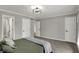 Bedroom features gray accent wall, modern lighting, and gray carpet at 4339 Royal Pine Blvd, Indianapolis, IN 46250