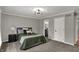 Bedroom features a gray accent wall, modern lighting, and gray carpet at 4339 Royal Pine Blvd, Indianapolis, IN 46250