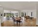 Open concept dining room and living room with hardwood floors, neutral color scheme and large windows offers relaxing scene at 4339 Royal Pine Blvd, Indianapolis, IN 46250