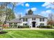 Charming two-story home features a well-manicured lawn, black trim, and an inviting entrance, with a beautiful blue sky at 4339 Royal Pine Blvd, Indianapolis, IN 46250
