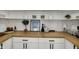 Kitchen with wood counters, white cabinets, open shelving, and stylish decor at 4339 Royal Pine Blvd, Indianapolis, IN 46250