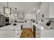 Stylish kitchen features white cabinets, a farmhouse sink, stainless steel appliances, and hardwood floors at 4339 Royal Pine Blvd, Indianapolis, IN 46250