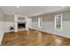Cozy living room with a fireplace, hardwood floors, and neutral wall paint offers a comforting retreat at 4339 Royal Pine Blvd, Indianapolis, IN 46250