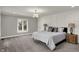 Bright main bedroom is carpeted and includes a large window to let in lots of natural light at 4339 Royal Pine Blvd, Indianapolis, IN 46250