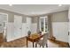 Well-lit office with hardwood floors, wainscoting and a window view creates an inviting space at 4339 Royal Pine Blvd, Indianapolis, IN 46250