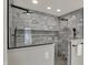 A luxurious tiled shower featuring a rainfall shower head and convenient built-in shelving at 4339 Royal Pine Blvd, Indianapolis, IN 46250