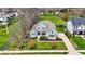Aerial view of a home with a large front yard, lush lawn, and mature trees at 4410 Miller Way, Westfield, IN 46062