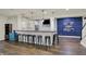 Basement bar area with wood countertop, white brick wall, pendant lighting, and seating at 4410 Miller Way, Westfield, IN 46062