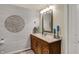 Cozy bathroom with a wooden vanity, ornate mirror, and seaside decorations at 4410 Miller Way, Westfield, IN 46062