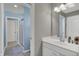 Bathroom vanity with a single sink, large mirror, walk-in shower, and neutral tile floors at 4410 Miller Way, Westfield, IN 46062