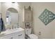 Powder room with decoratively appointed cabinet, arched mirror, and toilet at 4410 Miller Way, Westfield, IN 46062